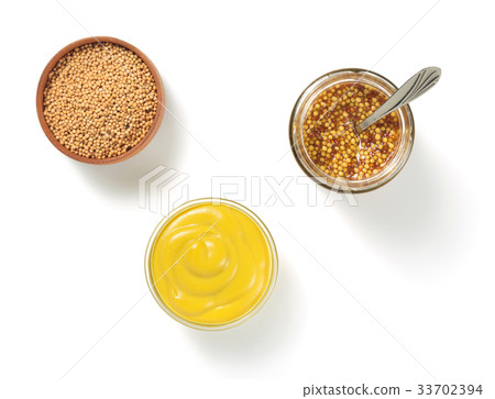 mustard sauce in bowl on white background 33702394
