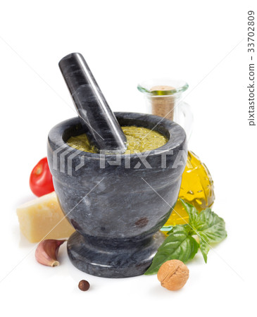 pesto sauce in mortar on white 33702809