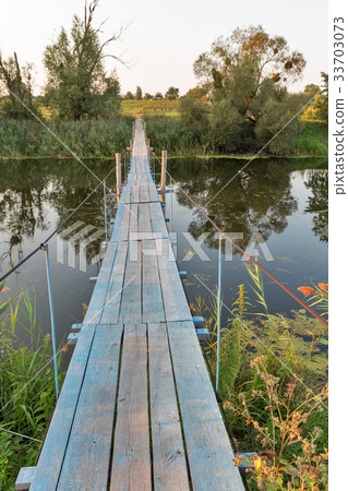 Suspended footbridge over the River Ros, Ukraine. Suspended footbridge over the River Ros, Ukraine. 33703073