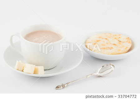 Cup of hot chocolate with cheese and arepa 33704772