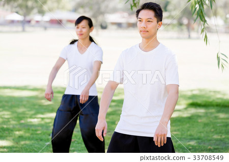 People practicing thai chi in park 33708549