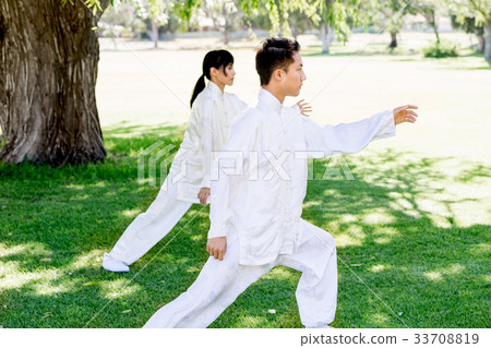 Handsome man practicing thai chi Handsome man practicing thai chi 33708819