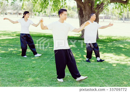 People practicing thai chi in park 33709772
