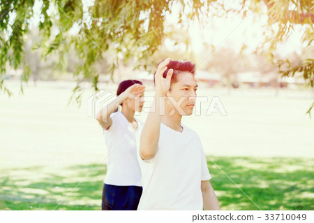 People practicing thai chi in park 33710049