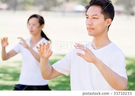 People practicing thai chi in park People practicing thai chi in park 33710233