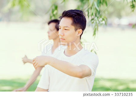 People practicing thai chi in park People practicing thai chi in park 33710235
