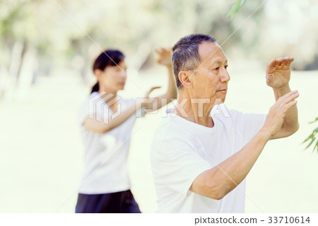 People practicing thai chi in park People practicing thai chi in park 33710614