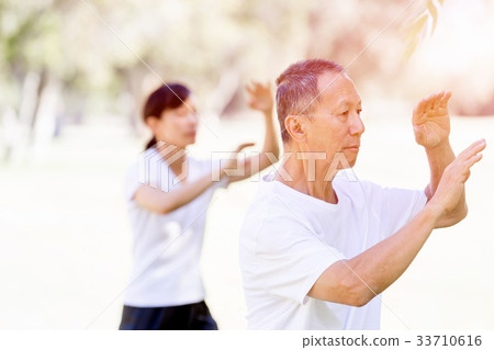 People practicing thai chi in park 33710616