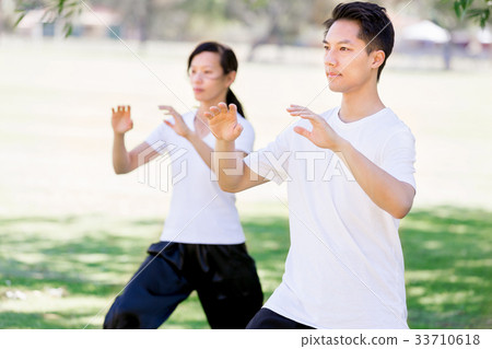People practicing thai chi in park 33710618