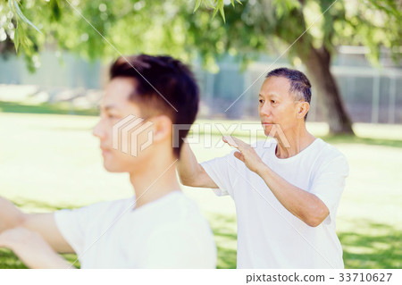 People practicing thai chi in park 33710627