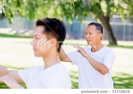 People practicing thai chi in park 33710629