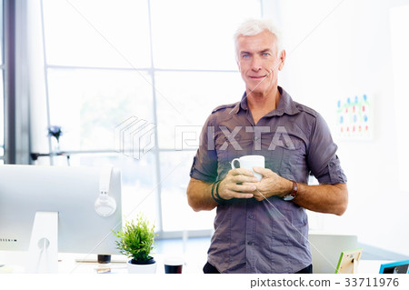 Handsome businessman in office 33711976