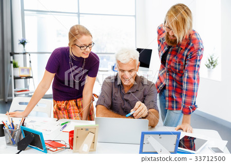 Co-workers working together Co-workers working together 33712500