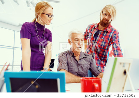 Co-workers working together 33712502