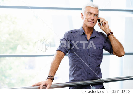 Handsome businessman in office Handsome businessman in office 33713200