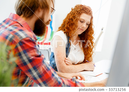 Co-workers working together 33713256
