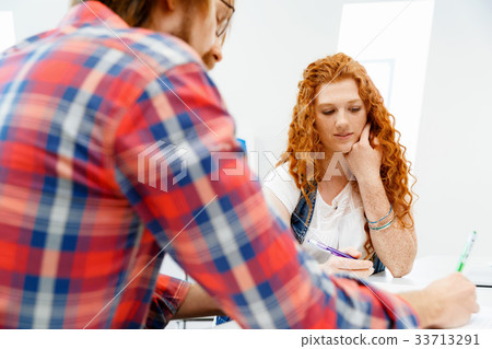 Co-workers working together 33713291