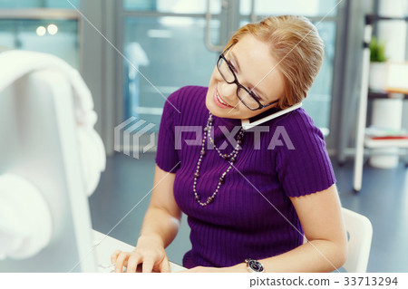Business woman in office holding mobile phone 33713294