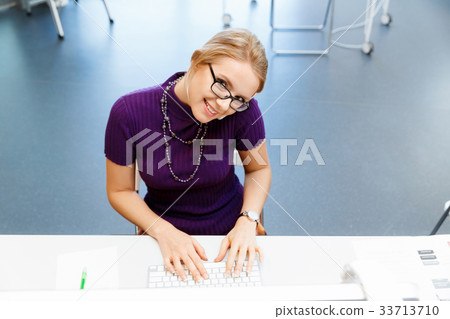 Business woman in office holding mobile phone 33713710