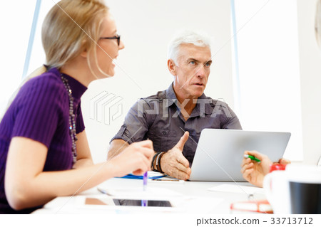 Co-workers working together 33713712