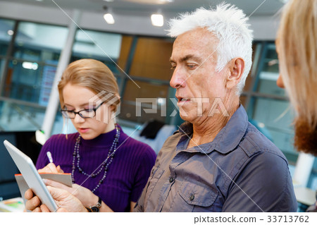 Co-workers working together Co-workers working together 33713762