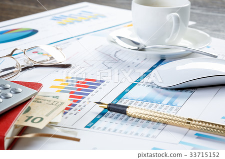 Financial charts and graphs on the table 33715152