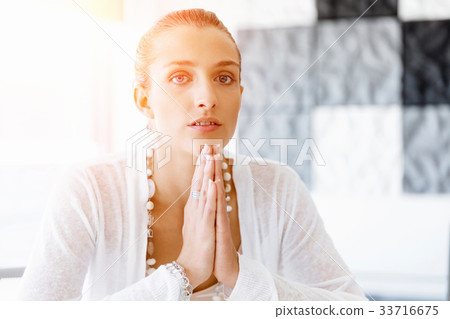 Attractive office worker sitting at desk 33716675