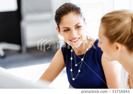 Two female colleagues in office 33716843