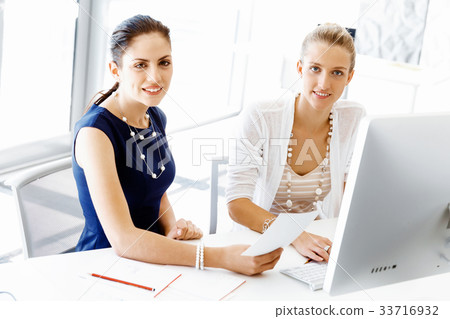 Two female colleagues in office Two female colleagues in office 33716932