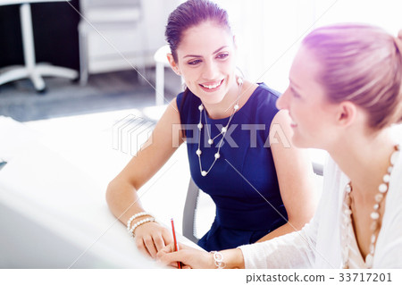 Two female colleagues in office Two female colleagues in office 33717201