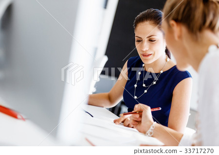 Two female colleagues in office Two female colleagues in office 33717270