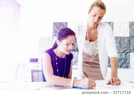 Two female colleagues in office Two female colleagues in office 33717338