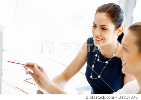 Two female colleagues in office Two female colleagues in office 33717376