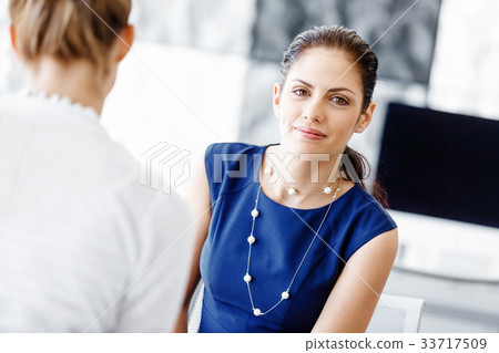 Two female colleagues in office Two female colleagues in office 33717509