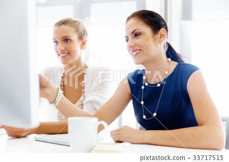 Two female colleagues in office 33717515