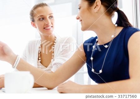 Two female colleagues in office Two female colleagues in office 33717560