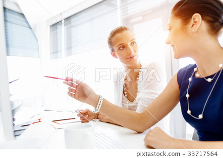 Two female colleagues in office Two female colleagues in office 33717564