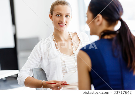 Two female colleagues in office 33717642