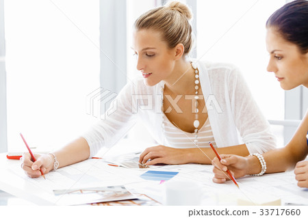 Two female colleagues in office Two female colleagues in office 33717660