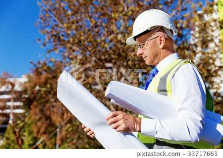 Engineer builder at construction site 33717661