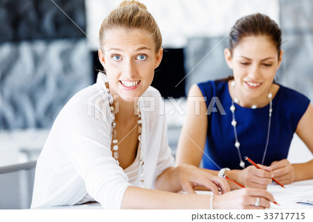 Two female colleagues in office 33717715