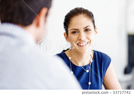Attractive office worker sitting at desk Attractive office worker sitting at desk 33717742