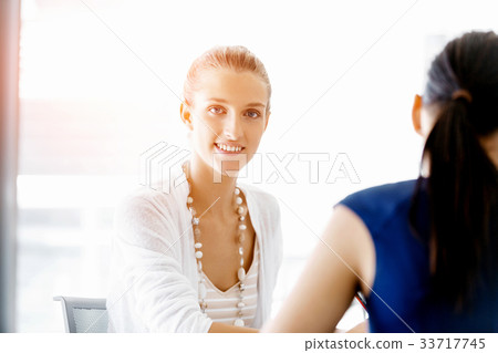 Two female colleagues in office Two female colleagues in office 33717745