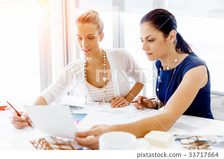 Two female colleagues in office 33717864