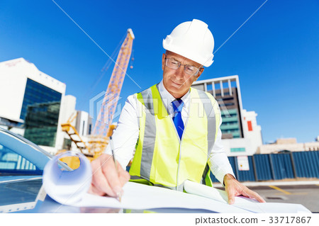 Engineer builder at construction site 33717867