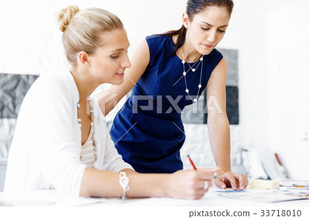 Two female colleagues in office 33718010