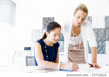 Two female colleagues in office 33718020
