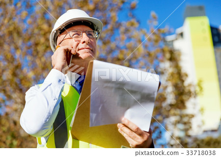 Engineer builder at construction site 33718038