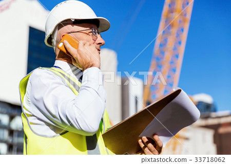 Engineer builder at construction site 33718062