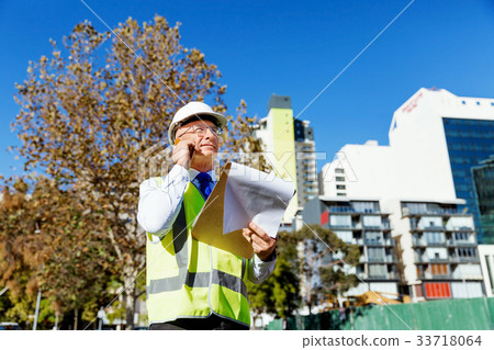 Engineer builder at construction site 33718064